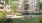 a person sitting on a bench in a park in front of a building