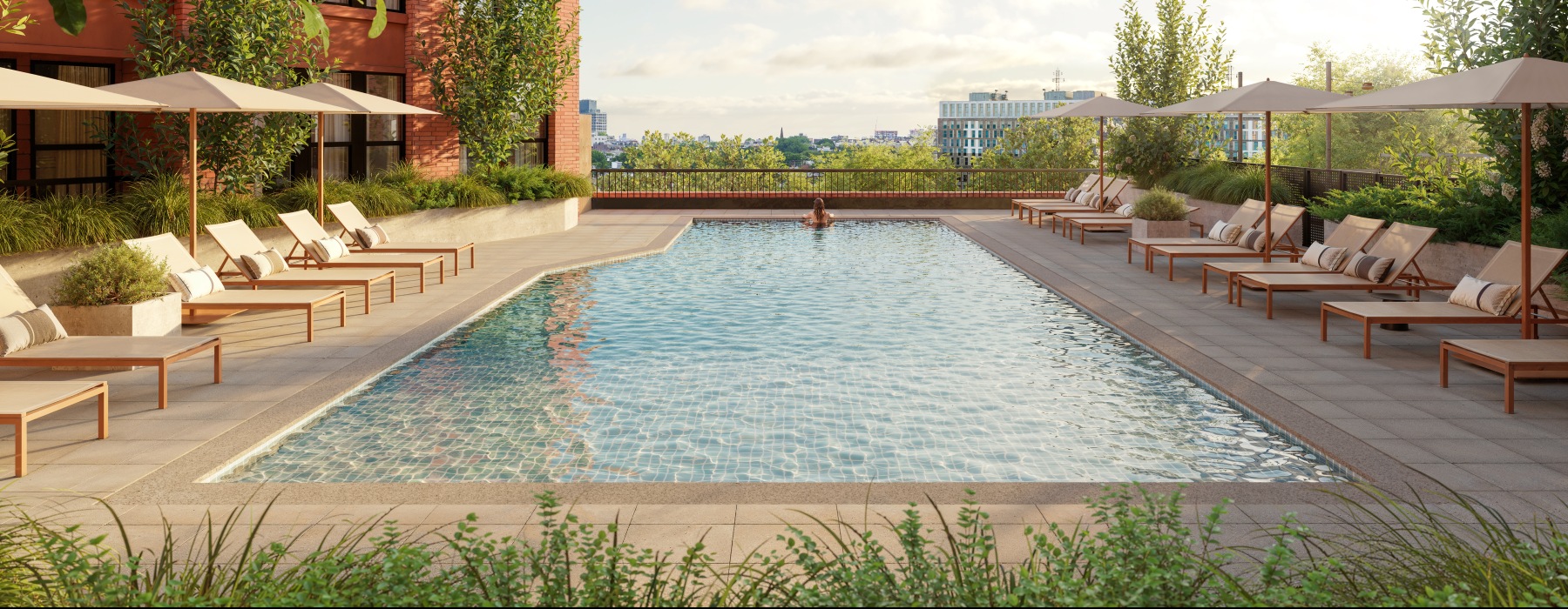 a pool with lounge chairs and umbrellas next to it